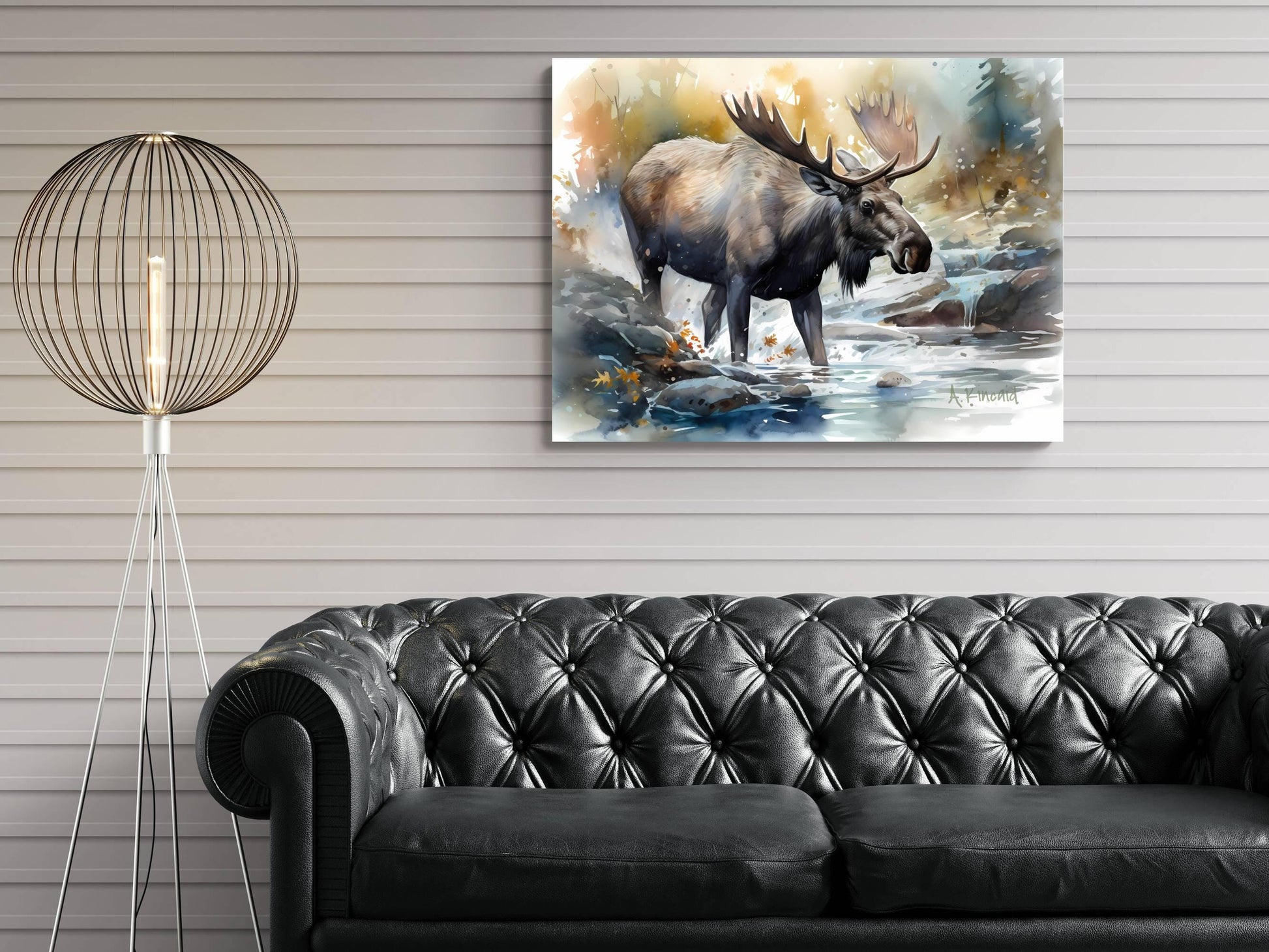 a large painting of a moose standing in a river, hanging on a wall above a black leather couch.