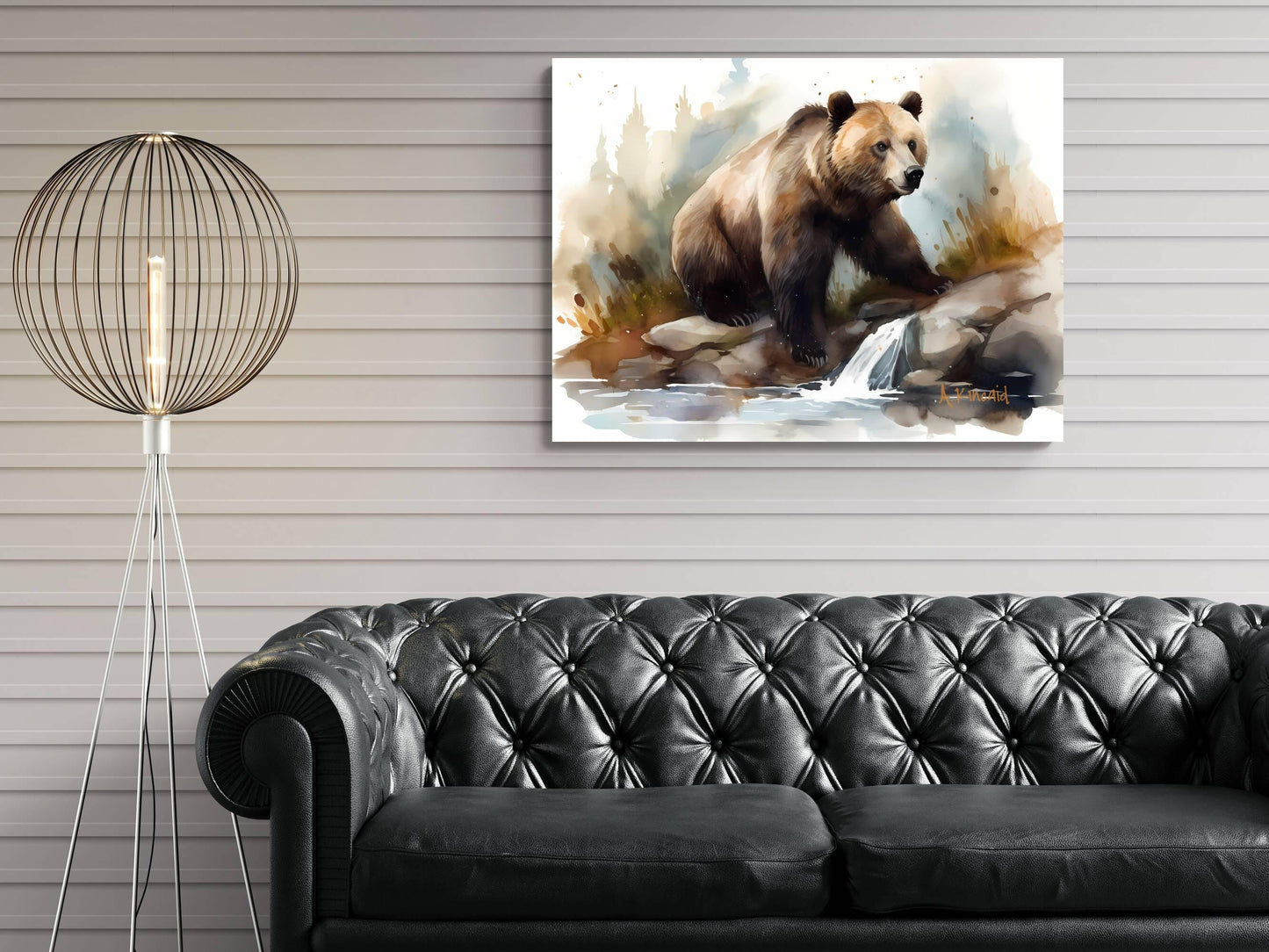 a painting of a bear on a rock, hanging on a wall above a black leather couch.