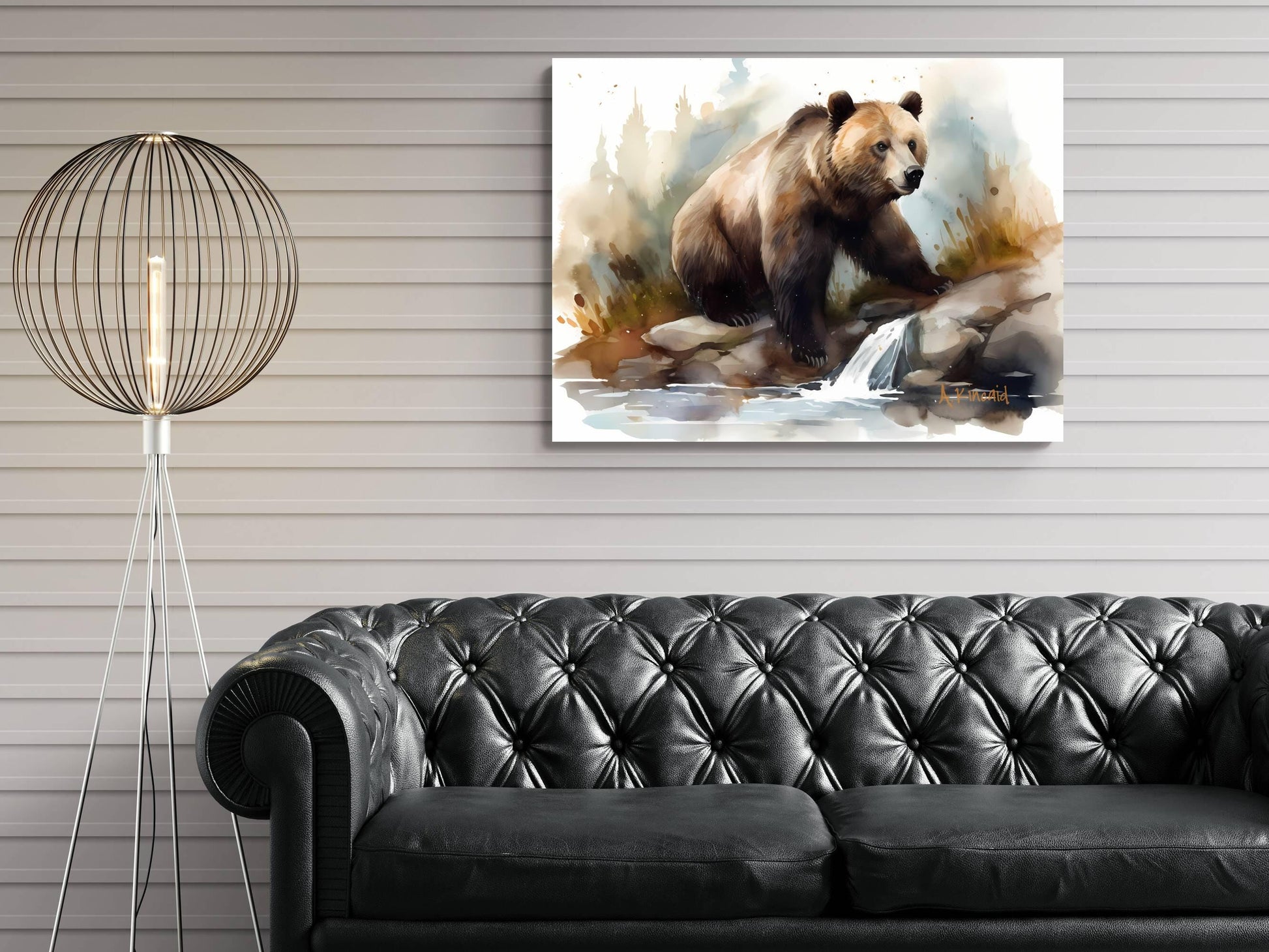a painting of a bear on a rock, hanging on a wall above a black leather couch.