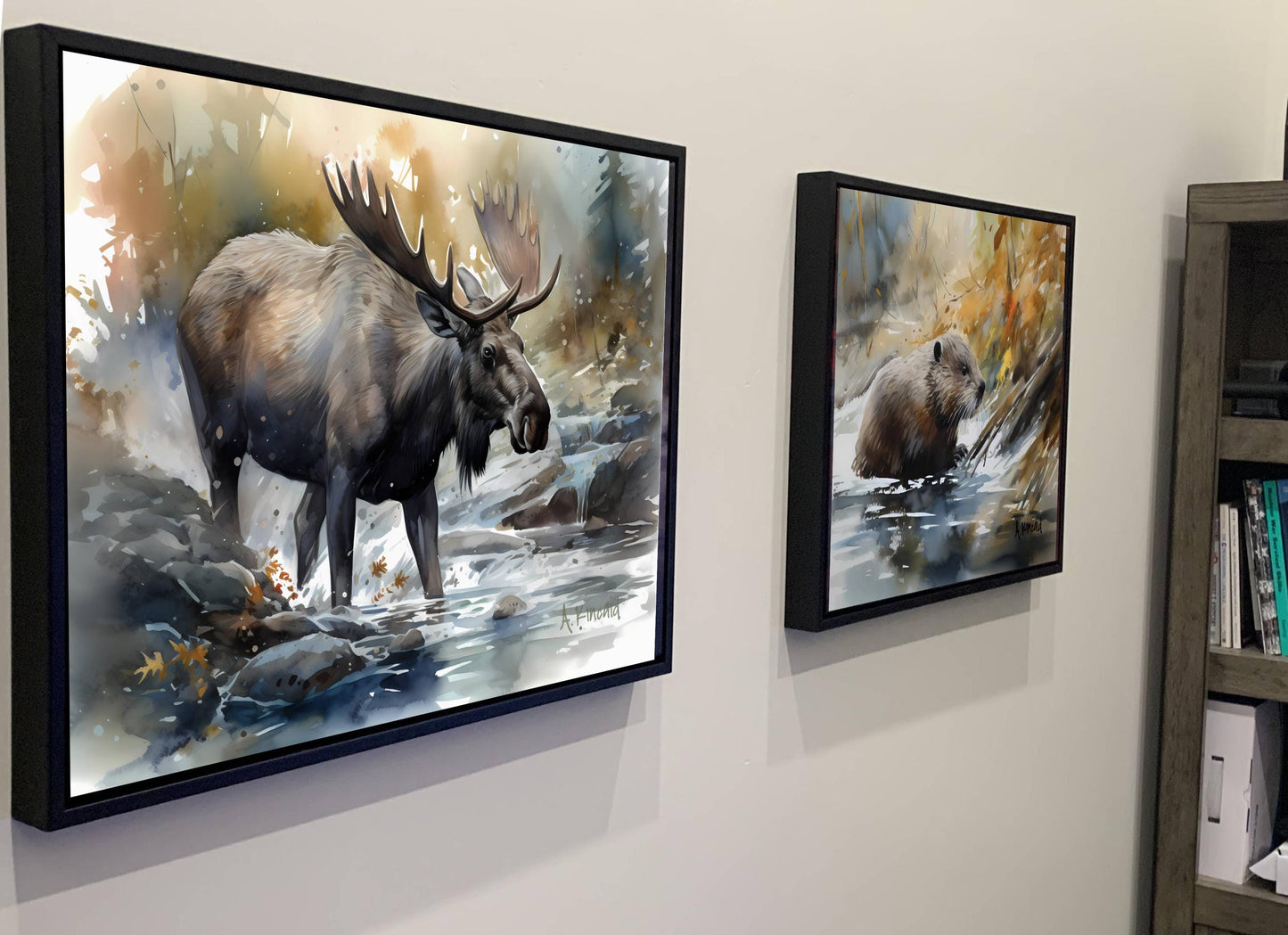 two framed paintings of moose and bears hanging on a wall.
