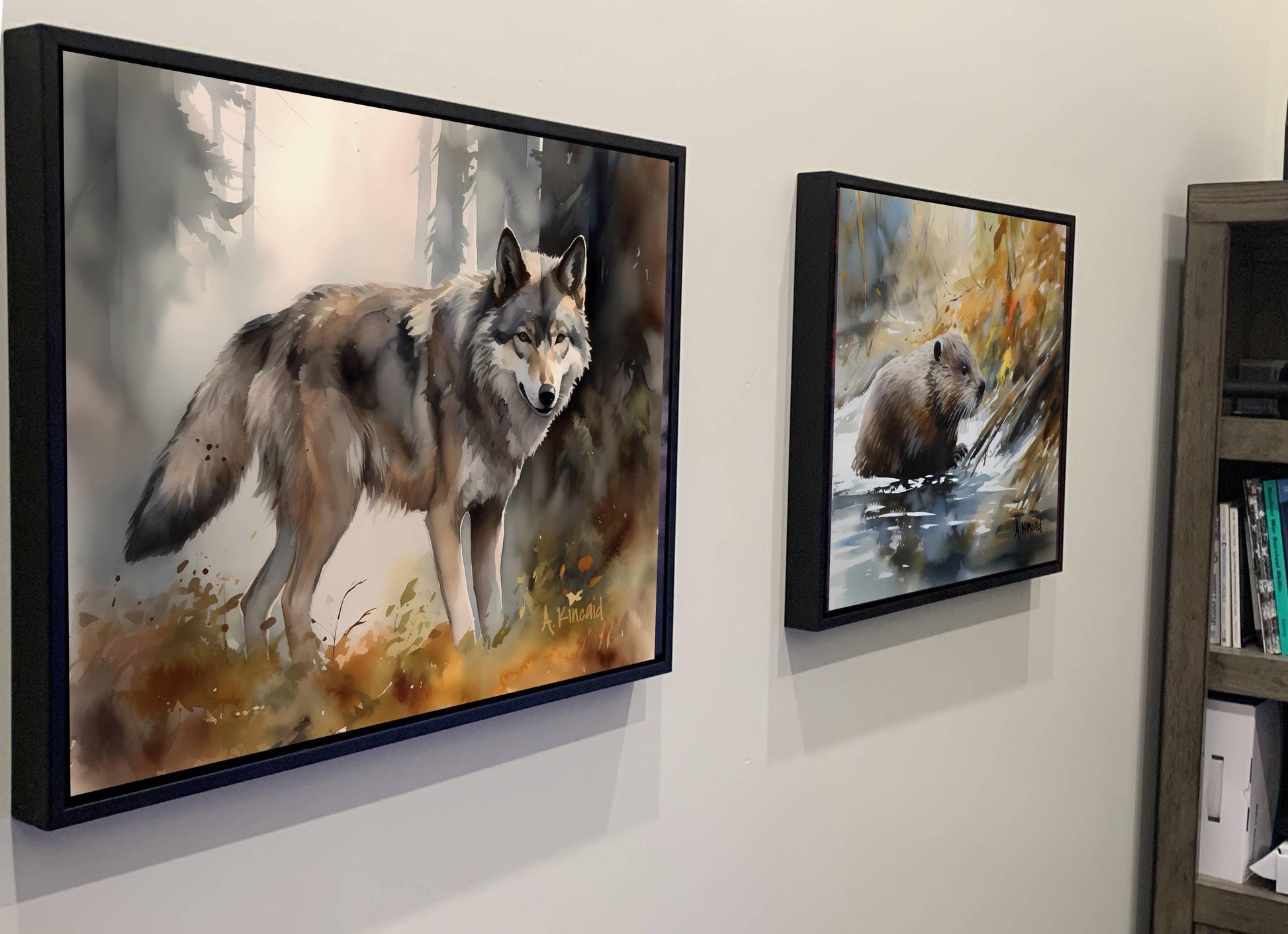 two framed paintings of animals, one of a wolf and the other of a bear, hanging on a wall.
