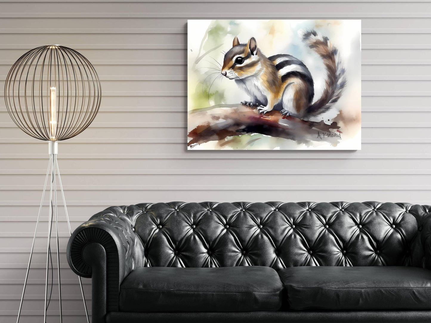 a painting of a squirrel perched on a branch, hanging on a wall above a black leather couch.