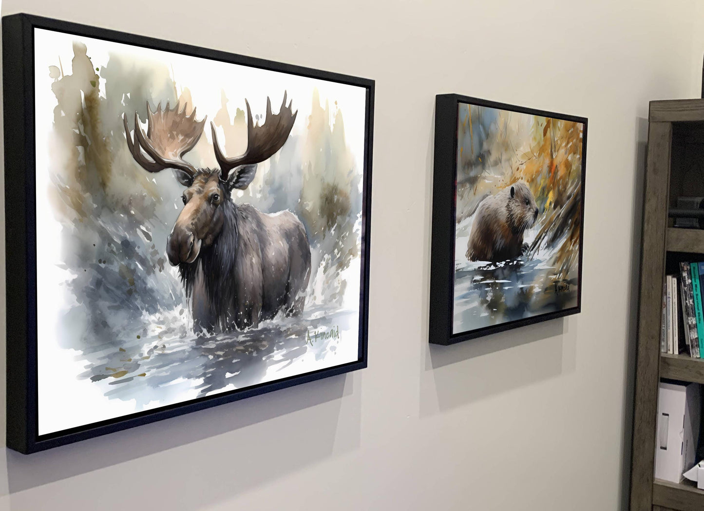 two framed paintings of moose and bears hanging on a wall.