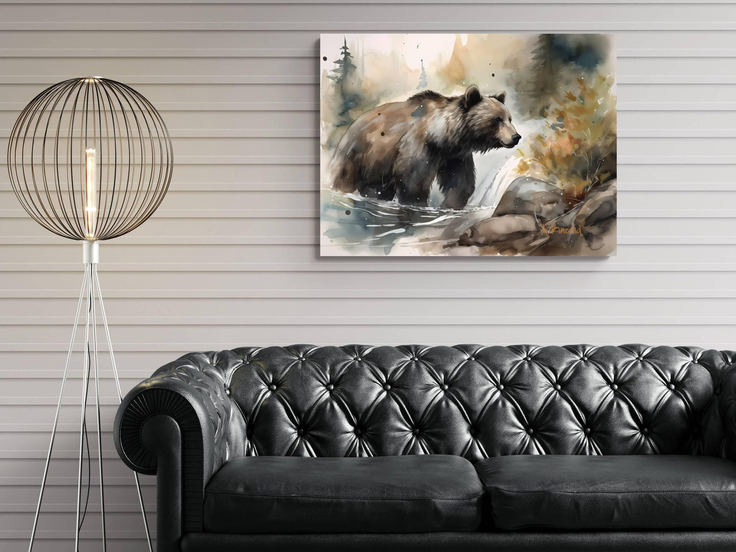 a painting of a bear in a natural setting, hanging on a wall above a black leather couch.