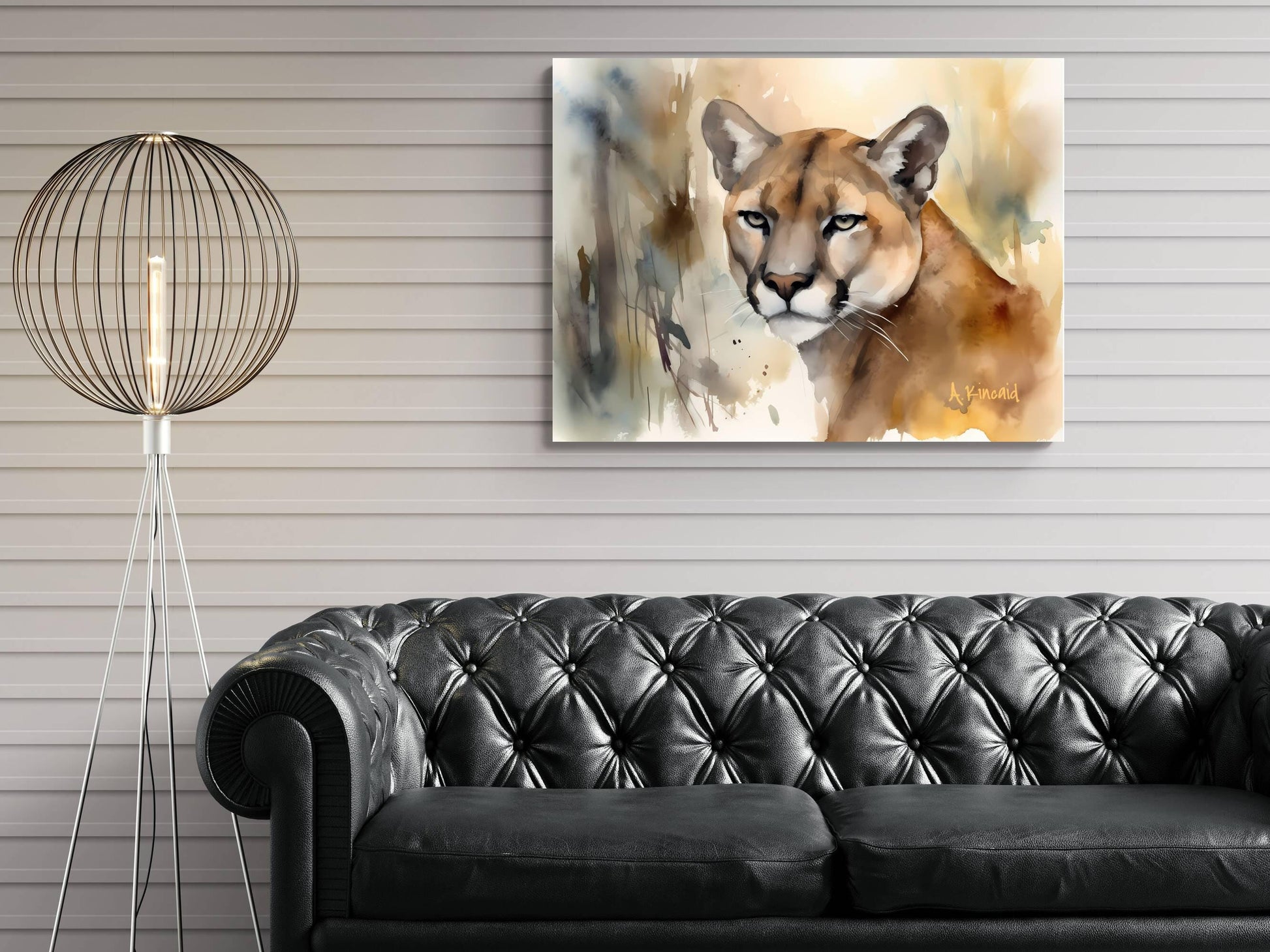 a black leather couch in a living room setting, with a painting of a cougar hanging on the wall above it.