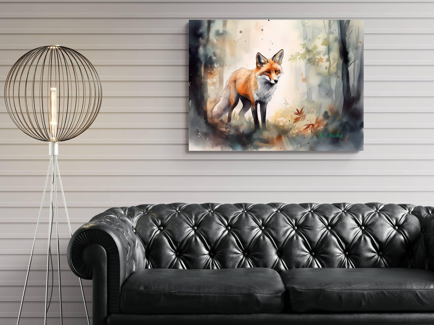 a painting of a fox in a forest setting, hanging on a wall above a black leather couch.