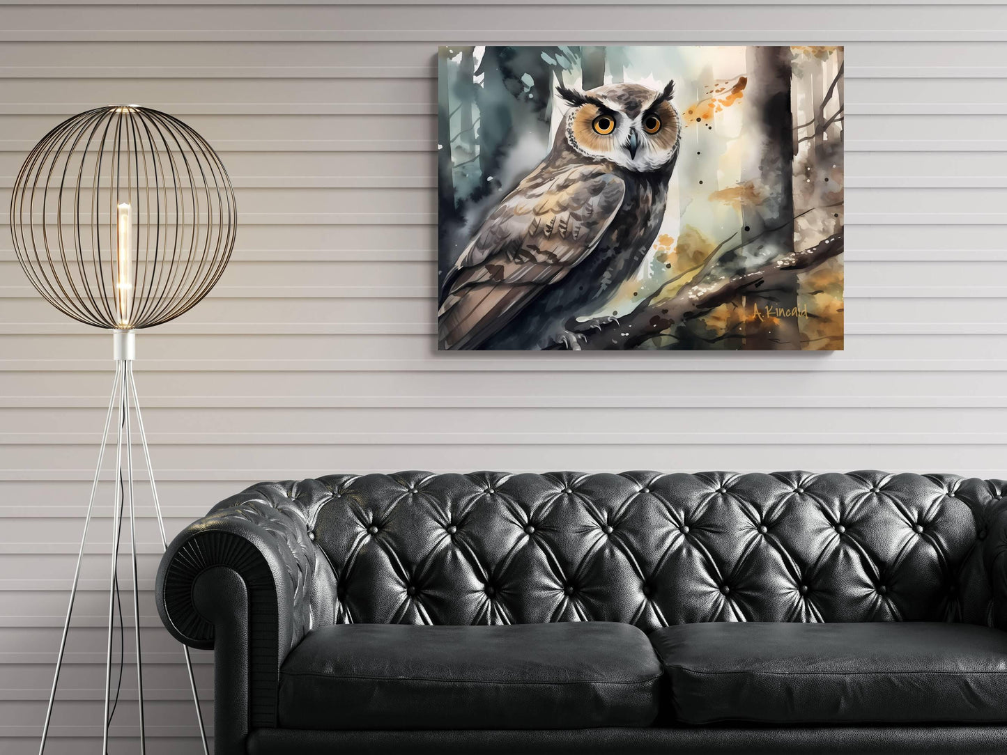 a large painting of an owl hanging on a wall above a black leather couch.
