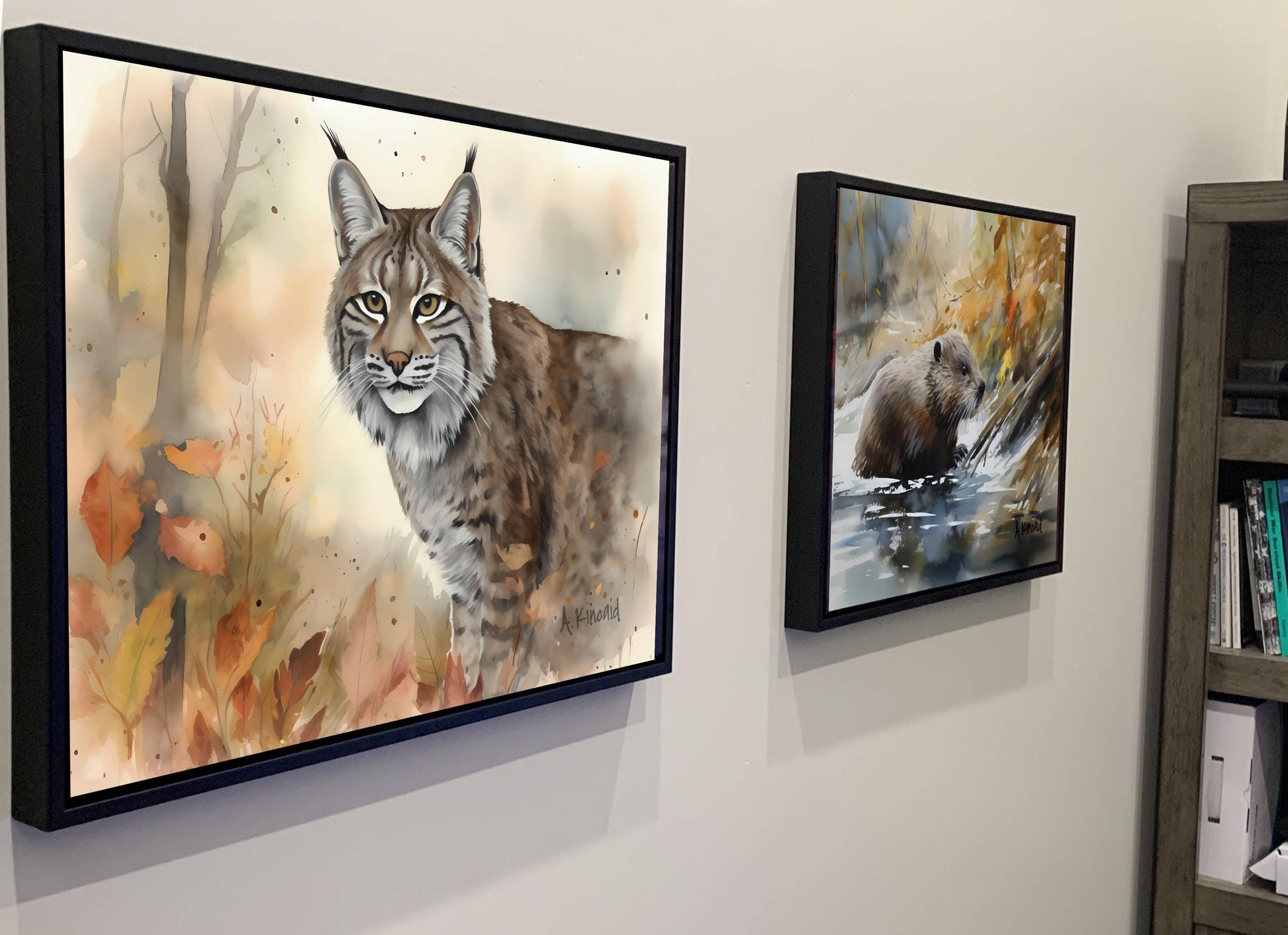 two framed paintings of animals, one of a bobcat and the other of a beaver, hanging on a wall.