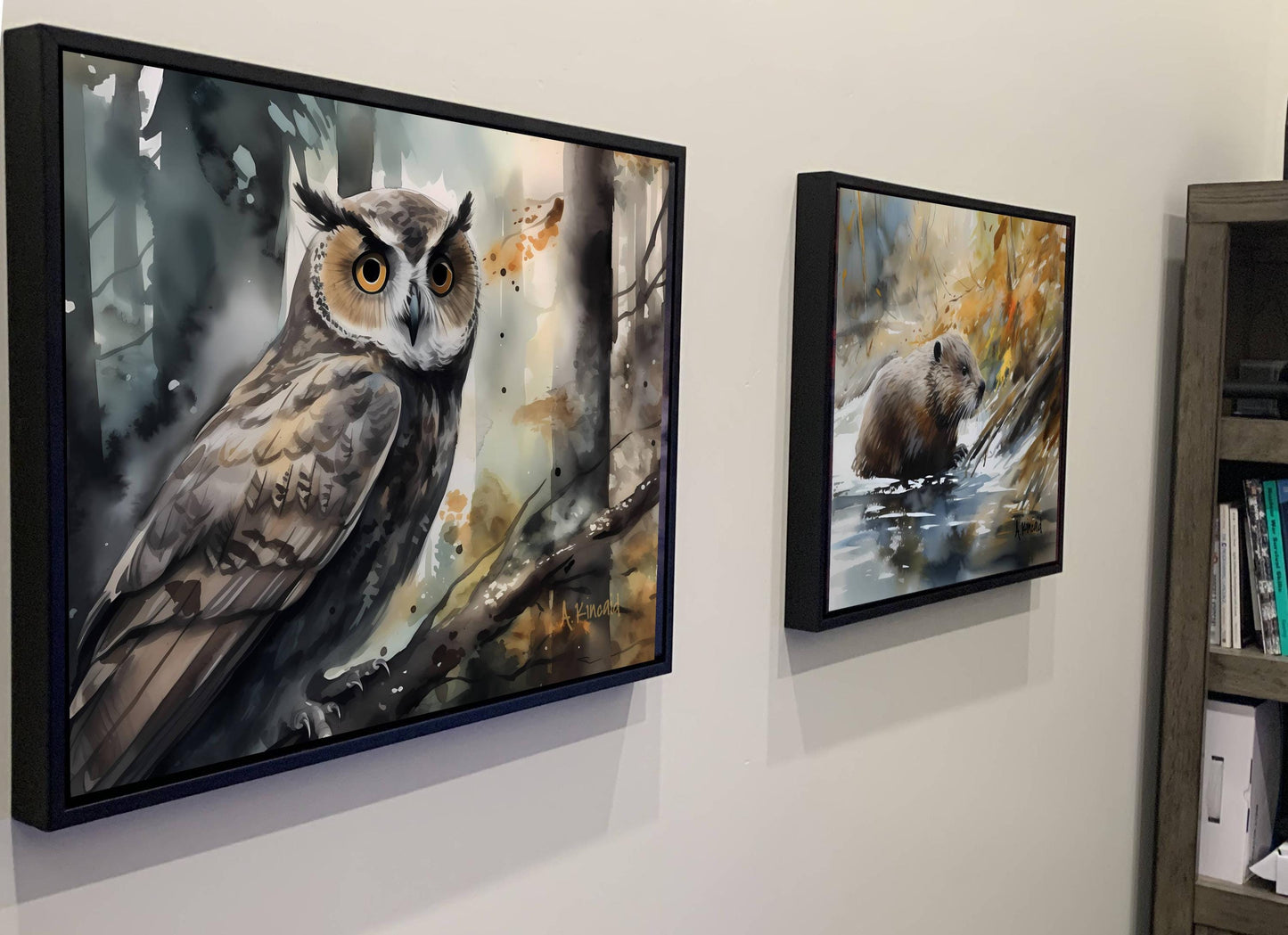 two framed paintings hanging on a wall, depicting an owl and a beaver in a forest setting.