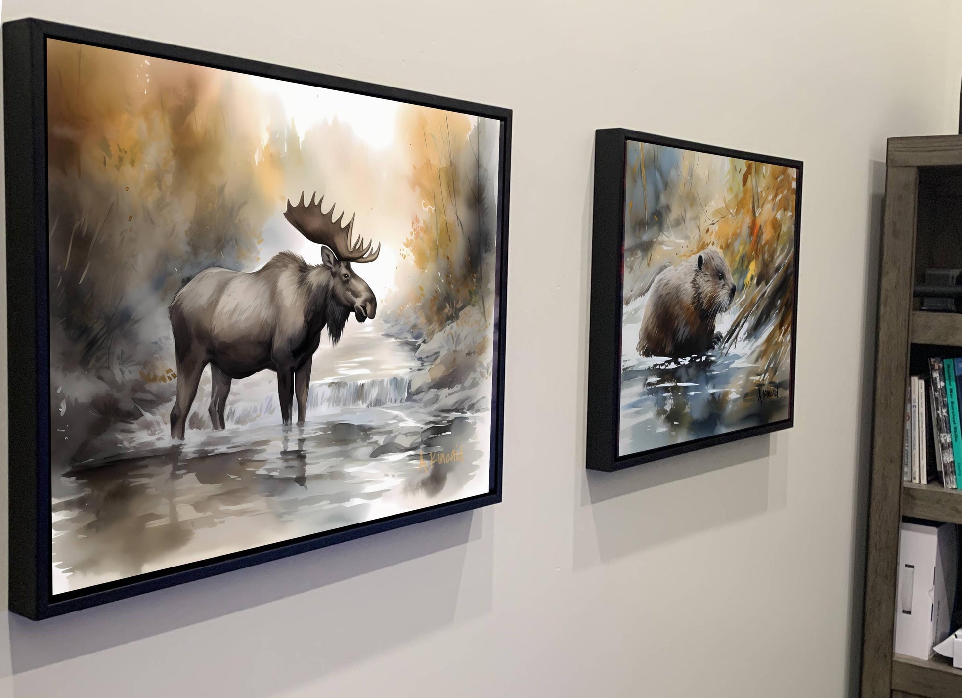 two framed paintings of moose and bears hanging on a wall.