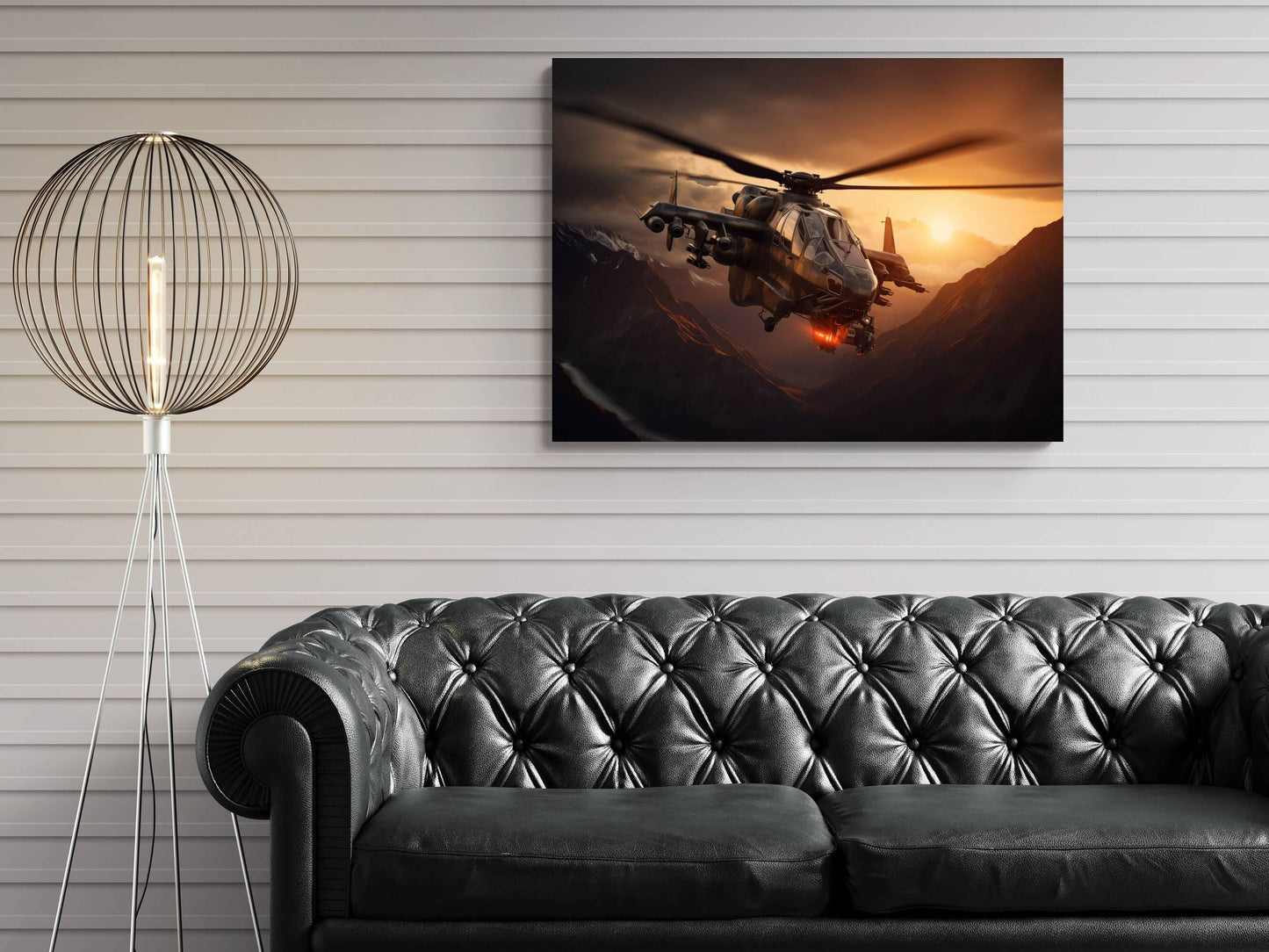 a large black leather sofa in a living room setting, with a framed artwork of a helicopter flying over mountains in the background.