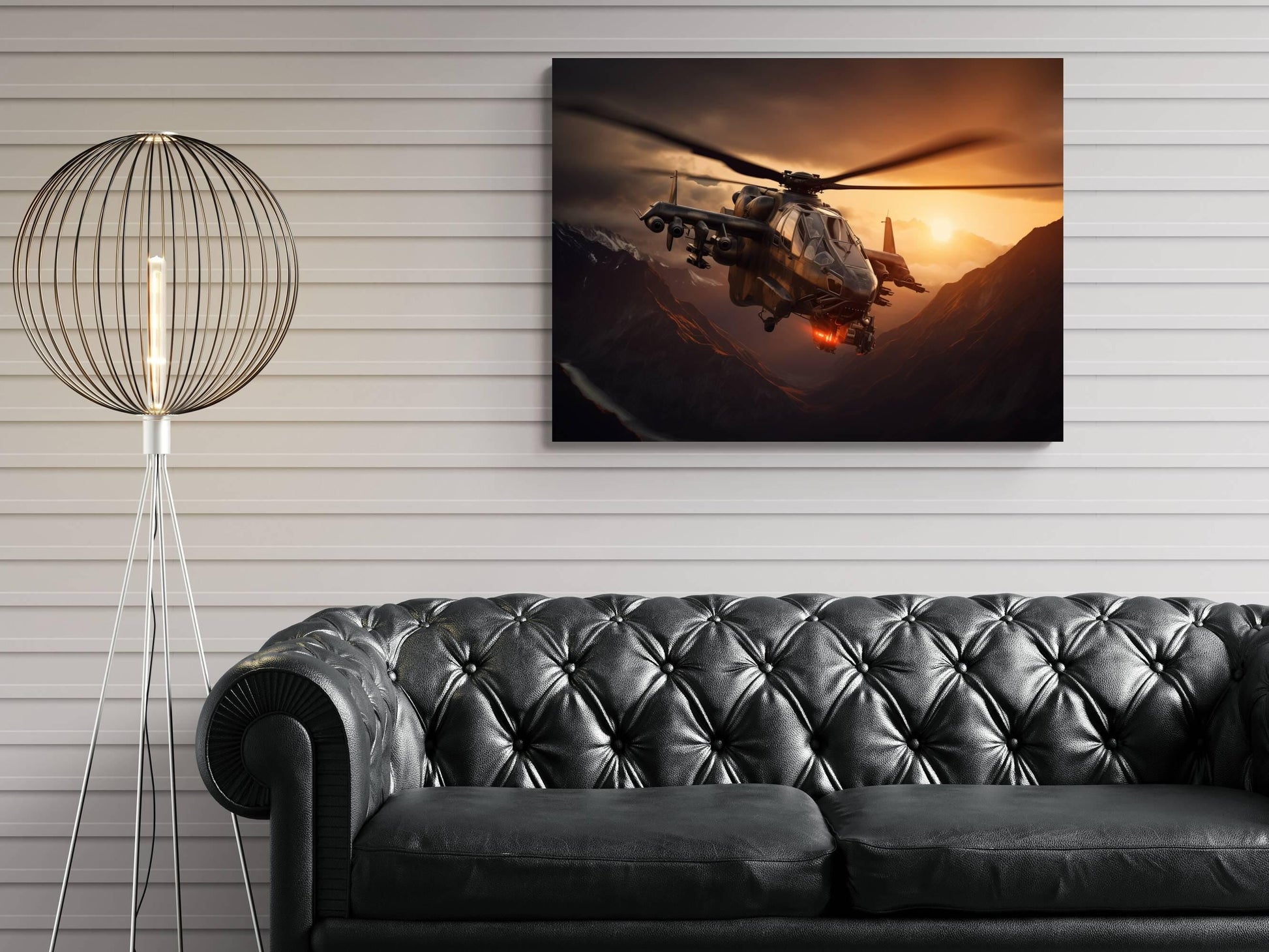 a large black leather sofa in a living room setting, with a framed artwork of a helicopter flying over mountains in the background.