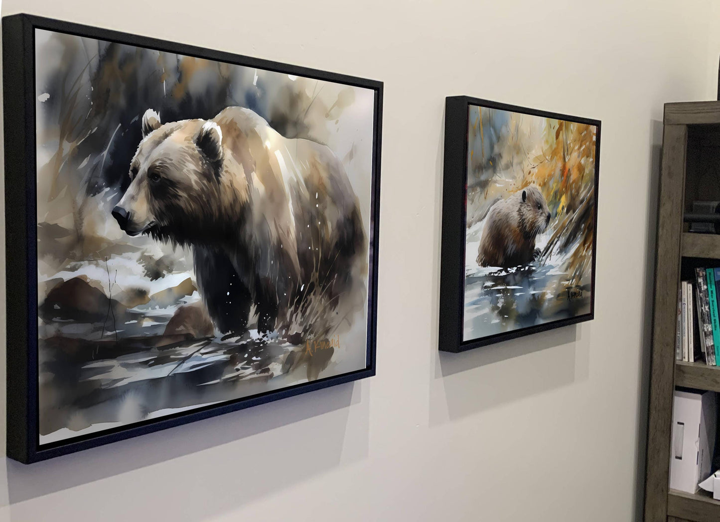 two framed paintings of bears, one larger and one smaller, hanging on a wall.