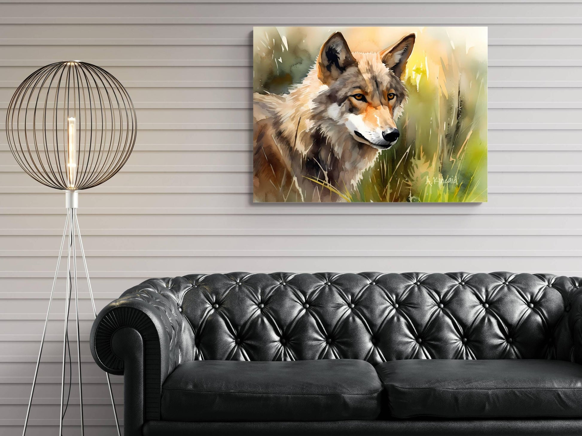 a large painting of a wolf in a grassy field hanging on a wall above a black leather couch.
