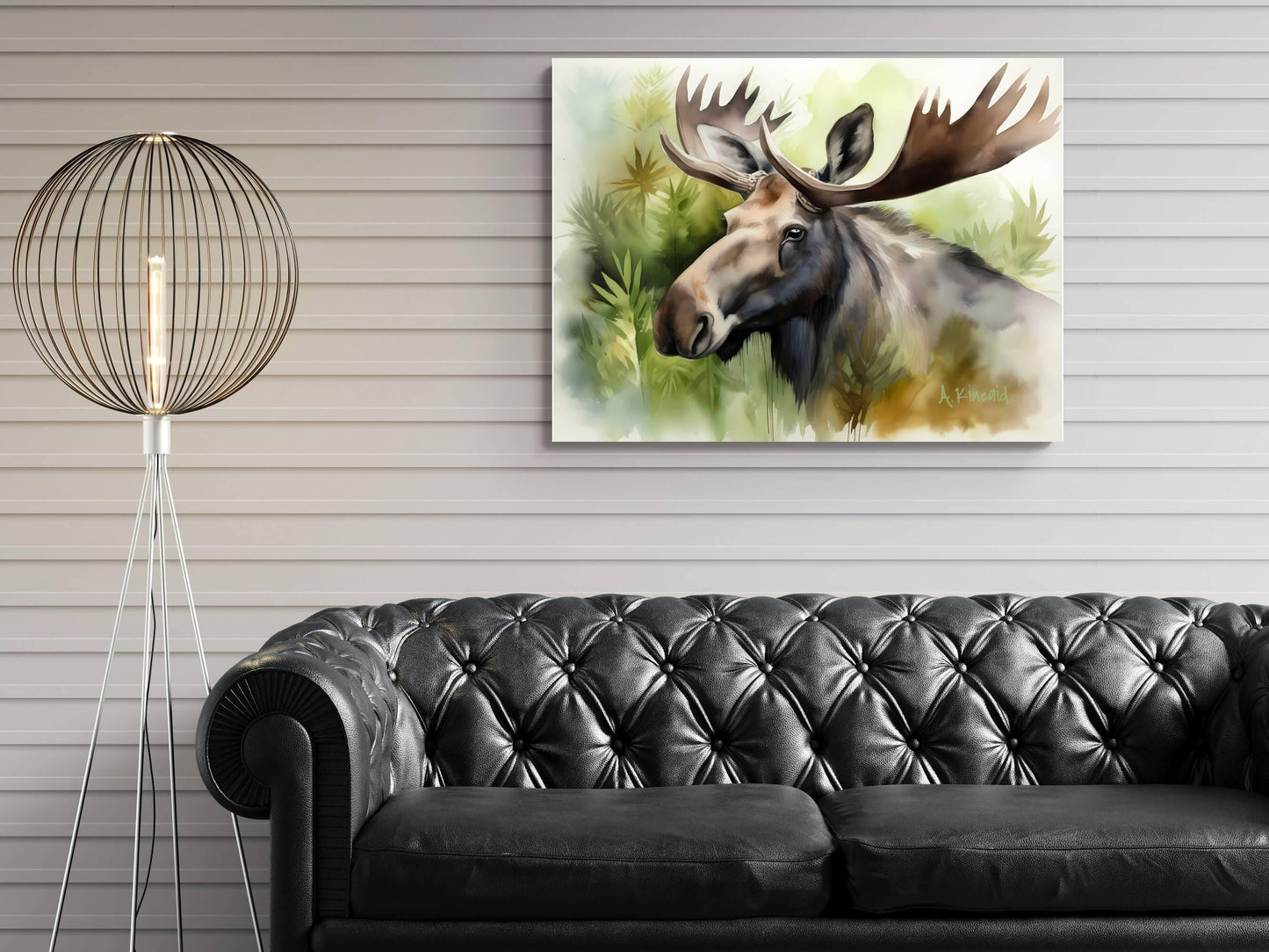 a large painting of a moose hanging on a wall above a black leather couch in a living room setting.