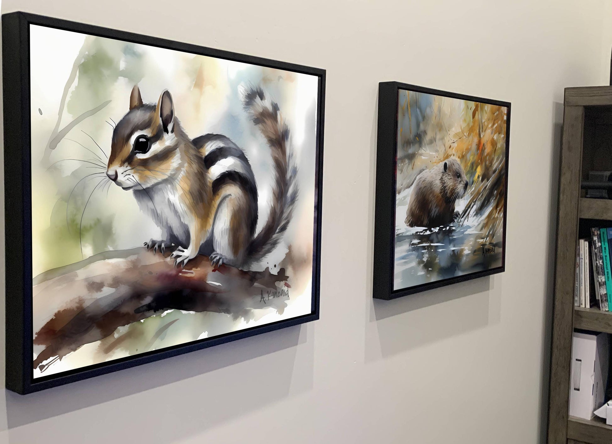 two framed paintings of animals, one of a squirrel and the other of a beaver, hanging on a wall.