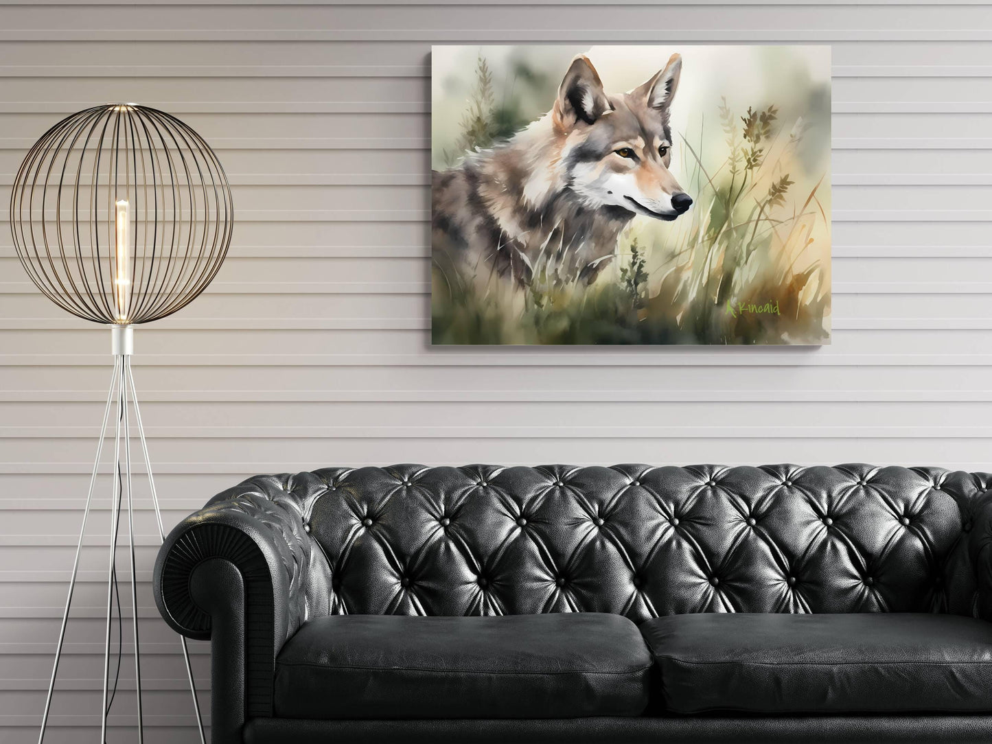 a large painting of a wolf in a grassy field hanging on a wall above a black leather couch.