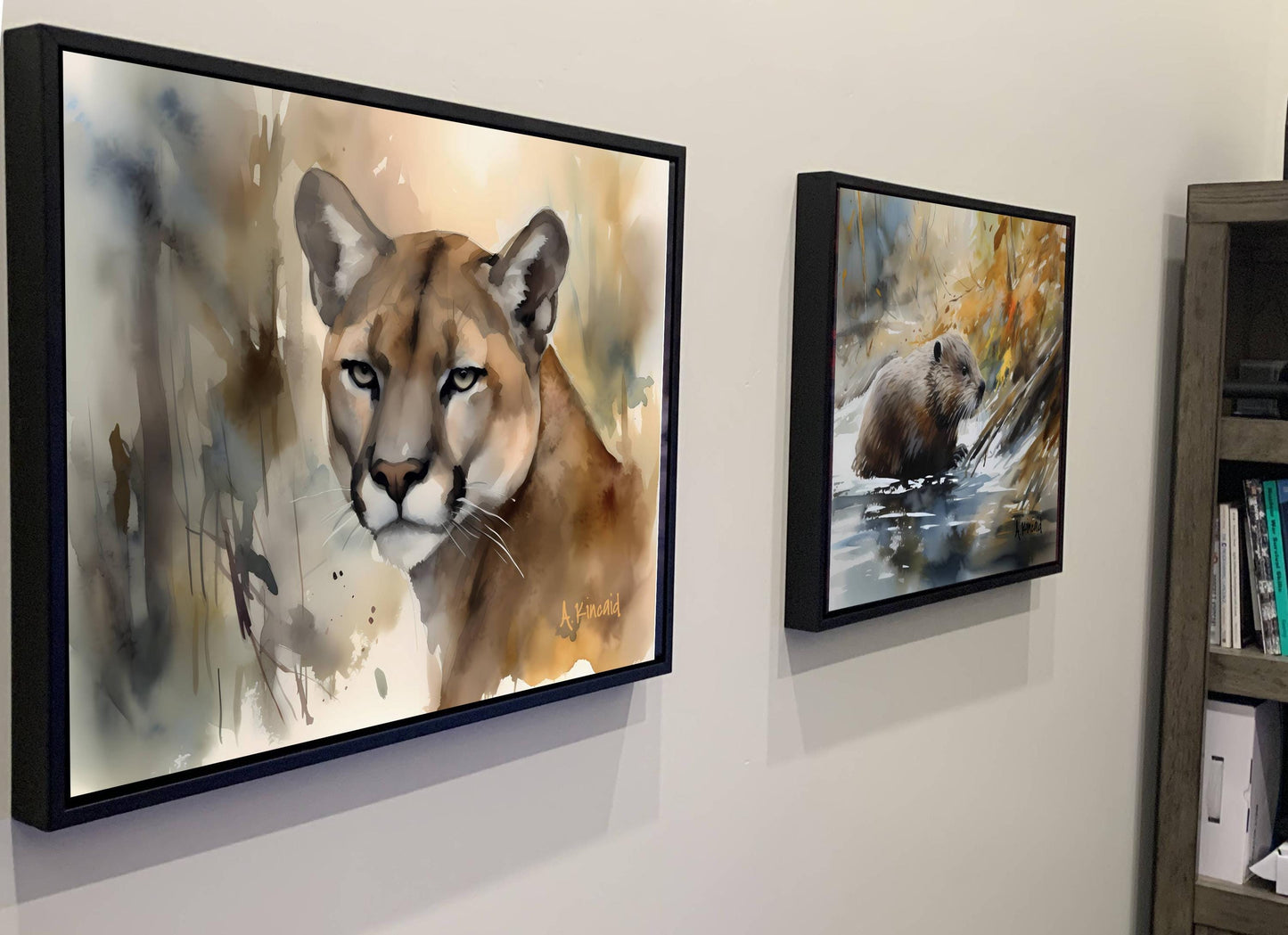 two framed paintings hanging on a wall, depicting a cougar and a bear in their natural habitats.